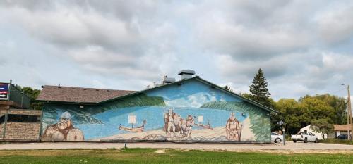 a building with a mural on the side of it at VIKING INN in Gimli