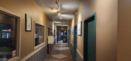 a hallway in a building with paintings on the walls at VIKING INN in Gimli
