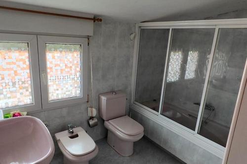 a bathroom with a toilet and a sink and a tub at Apartamento cerca de la playa in Santander