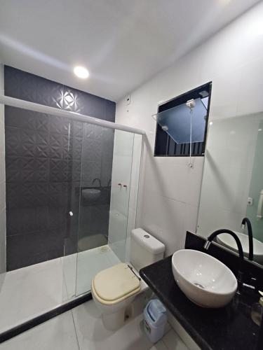 a bathroom with a shower and a toilet and a sink at Loft em Olaria in Rio de Janeiro