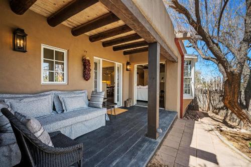 a porch with a couch and chairs on a house at Casa TATIZ • Privacy in a Southwestern Gem in Santa Fe