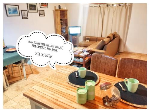 吉拉諾貝爾格拉諾的住宿－Casa Casuarina，客厅配有桌子和沙发