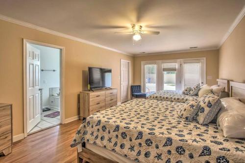 a bedroom with a large bed and a television at Elegant Huge Ocean View 4 King, Private Pool, Huge Yard, Enormous Game Garage, BBQ, & Rooftop Deck in Myrtle Beach