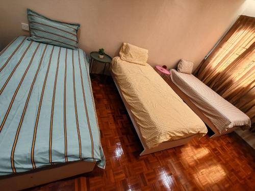 a bedroom with two beds in a room at A Humble Abode Homestay By irainbow in Ipoh