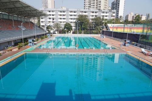 a large swimming pool with blue water in a city at Country Inn & Suites By Umrb - Mumbai International Airport in Mumbai