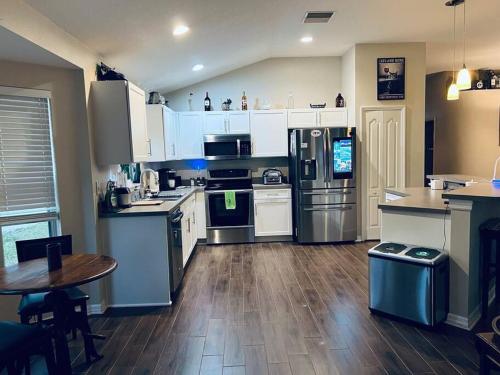 a kitchen with stainless steel appliances and a wooden floor at Ruskin FL private 2 bdrm 1 bath suite Common areas shared with host in Ruskin