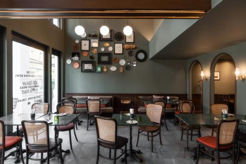 a restaurant dining room with tables and chairs at Burirattana Hotel-An Adults Only Hotel in Chiang Mai