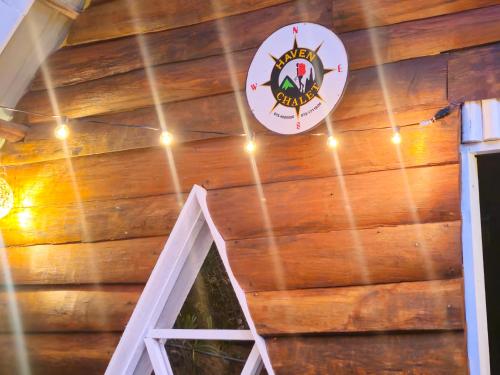 a sign on the wall of a barn with lights at haven Chalet in Nuwara Eliya