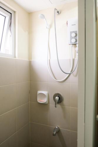 a shower in a bathroom with a window at Spacious 1BR Corner Unit in IT Park in Cebu City