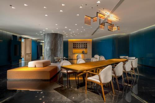 a dining room with a wooden table and chairs at The Westin Yantai in Yantai