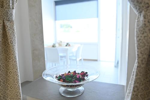 a bowl of flowers sitting on a table at casa Venezia in Carovigno