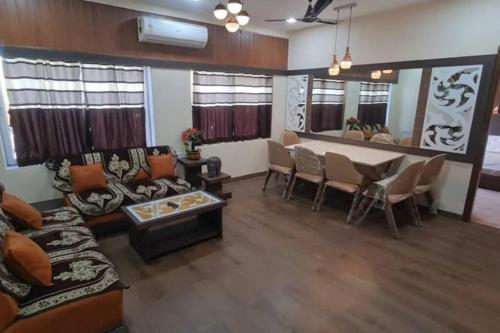 a living room with a couch and a table at Slice Of Heaven.3-Bedroom Villa with Pool & Gazebo in Lonavala