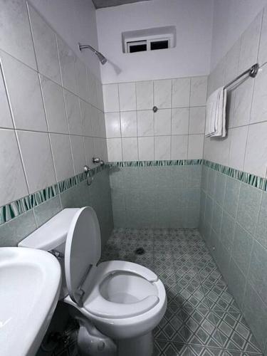 a bathroom with a toilet and a sink at Brisa del Mar #6 in Brisas de Zicatela