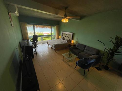 a living room with a couch and a bed at Brisa del Mar #6 in Brisas de Zicatela