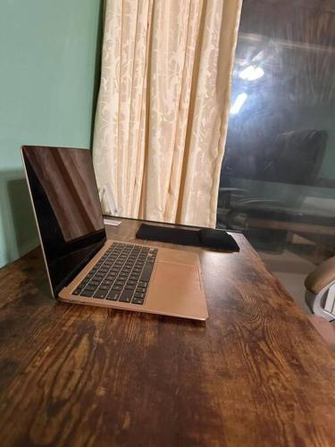 a laptop computer sitting on top of a wooden table at Brisa del Mar #6 in Brisas de Zicatela