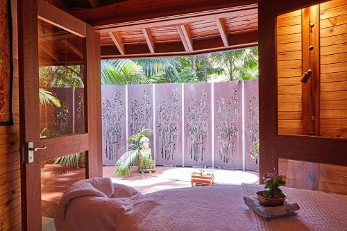 an open door to a room with a garden outside at Arajilla Retreat in Lord Howe