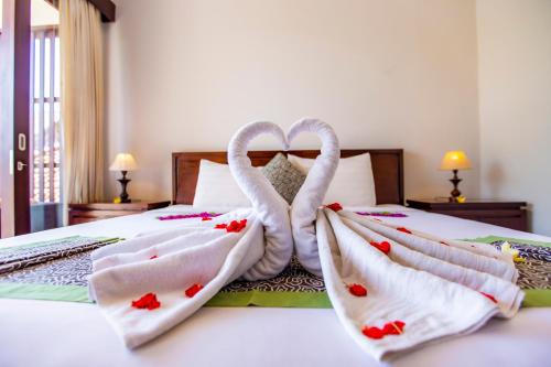 Ένα ή περισσότερα κρεβάτια σε δωμάτιο στο Lili Cottage Ubud