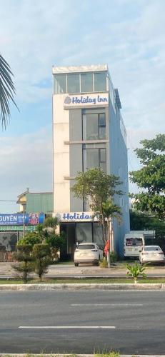 a building with a car parked in front of it at Holiday Inn Hotel in Da Nang