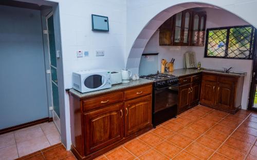 a kitchen with a microwave on top of a counter at Nyumbani Palace Arusha in Arusha