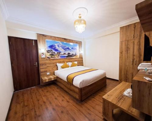 a bedroom with a bed and a chandelier at Prem Durbar Hotel & Nagarkot Zipline in Nagarkot