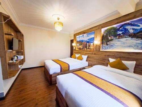 a hotel room with two beds and a painting on the wall at Prem Durbar Hotel & Nagarkot Zipline in Nagarkot