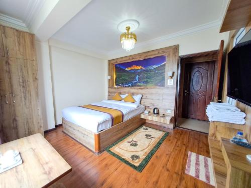 a bedroom with a bed and a tv in it at Prem Durbar Hotel & Nagarkot Zipline in Nagarkot