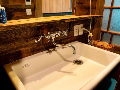 a sink with a faucet in a bathroom at GOYADO in Ozu