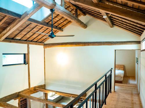a staircase in a house with wooden ceilings at GOYADO in Ozu