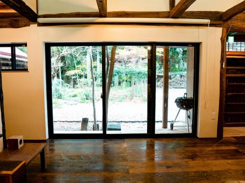 a room with a large sliding glass door at GOYADO in Ozu