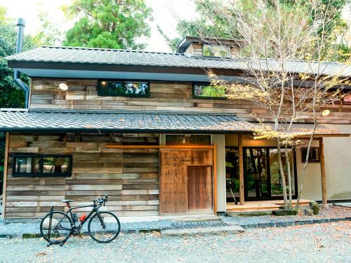 a bike parked in front of a wooden house at GOYADO in Ozu
