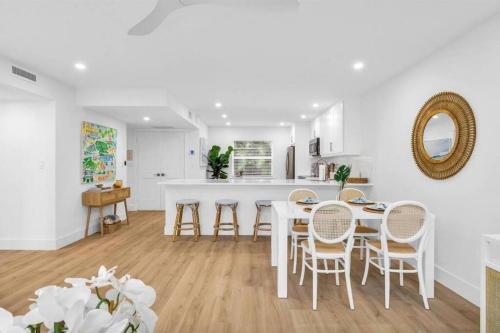a kitchen and dining room with a table and chairs at Luxury Beachside Condo 1 Steps to the Beach in Juno Beach