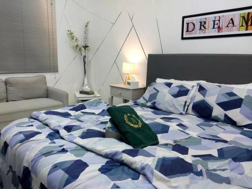 Private Bedroom in a Home With Park View في الشارقة: غرفة نوم بسرير لحاف ازرق وبيض
