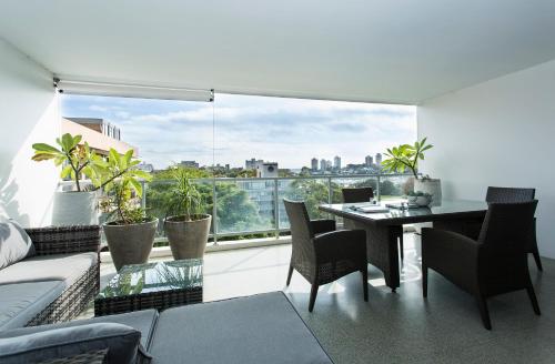 uma sala de estar com uma mesa e uma grande janela em Modern & Sleek, Minutes to the City. Parking/Pool em Sydney