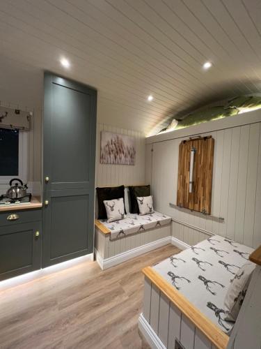 a room with two beds and a sink in it at Southfield Shepards Huts in Durham