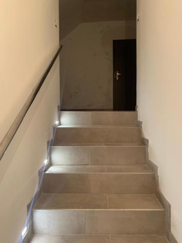 a stairway with a door leading up to a stair case at Zu Hause in Vrbov