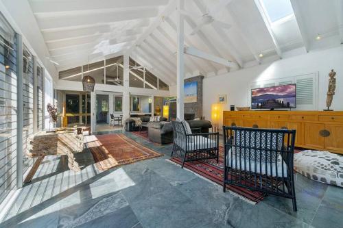 a large living room with a couch and a table at Fuller Holidays - Adrift - Tallows Beachfront Suffolk Park in Suffolk Park