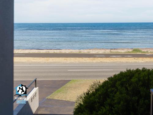an empty road with the ocean in the background at Three Level Esplanade Magic with Stunning Views in Encounter Bay