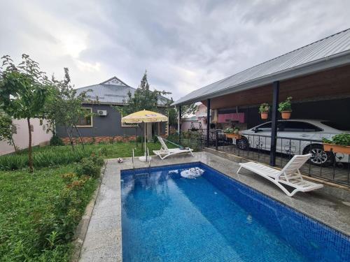 basen z dwoma krzesłami i dom w obiekcie Elnr Small swing pool villa w mieście Daşca