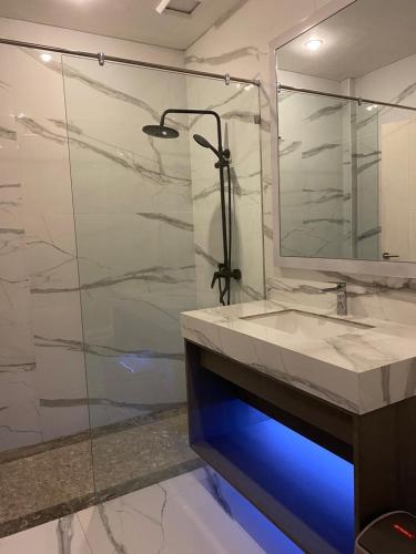 a bathroom with a glass shower and a sink at panfila hotel in Kuta Lombok
