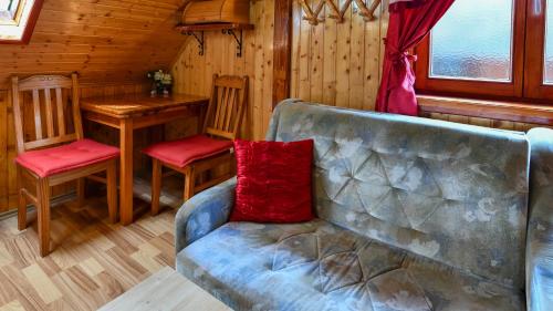 a living room with a couch and a table at Guest House Martin in Korana