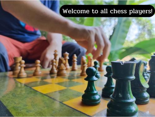 a man playing a game of chess on a chessboard at Sa Sa Lao in Luang Prabang