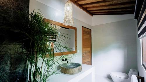 a bathroom with a tub in the corner of the room at petra bianca uluwatu in Uluwatu