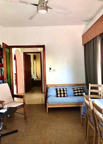 a living room with a blue couch in a room at Elesta in Vourvourou