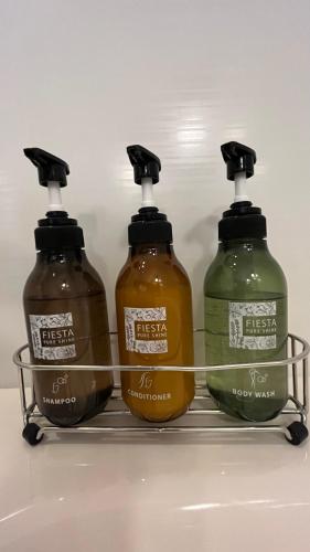 three bottles of laundry detergent sitting on a shelf in a refrigerator at KOKO HOTEL Premier Kanazawa Korinbo in Kanazawa