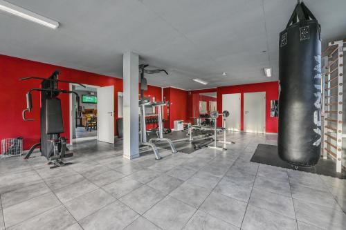 a gym with a punching bag in the middle of a room at smallville in Sion