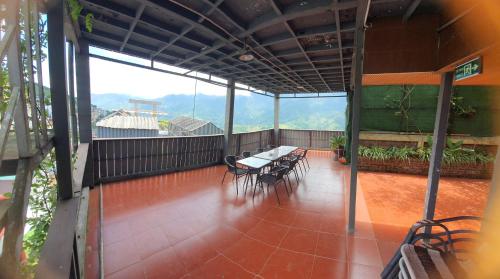 a balcony with tables and chairs in a building at Phuong Nam Hotel in Sa Pa