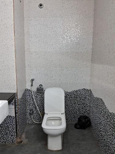 a bathroom with a white toilet in a shower at Luxury Villa Large Private Pool in Raichak