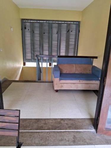 a couch sitting in a room with a window at Luxury Villa Large Private Pool in Raichak