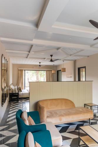 a living room with a bed and a couch at Vanaashrya Resort and Spa Sariska in Tehla