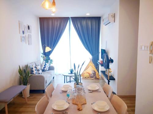 a living room with a table and a couch at Hanns&FreeWIFI&Washer+Pool@SunshineComfortHMStay3 in Sibu